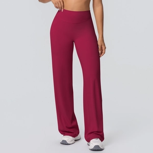 Detail of high-waist bordeaux red wide-leg yoga pants showing the elastic fabric and waistband
