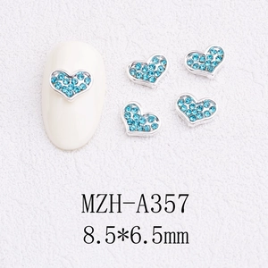 Detailed macro view of 8.5x6.5mm light blue heart rhinestones for nail art DIY designs