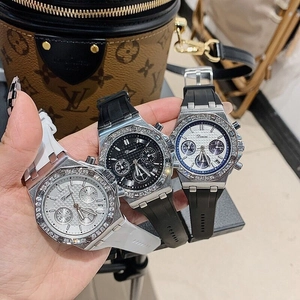 Close-up of three women's quartz watches with rhinestone bezels and silicone straps