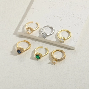 Detailed display of assorted luxury zircon rings in gold and silver on stone pedestals