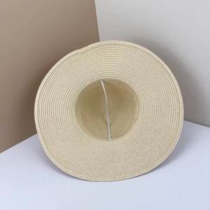 Vista dettagliata del cappello di paglia a tesa larga con trama intrecciata per il sole