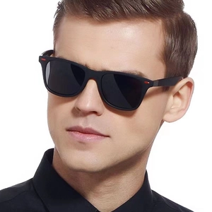 Classic black rectangular sunglasses with red side stripes on a male model face