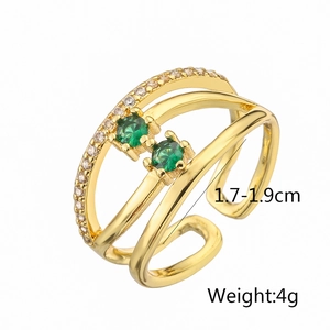 Detail view of gold geometric open ring with emerald cubic zirconia and white micro-crystals