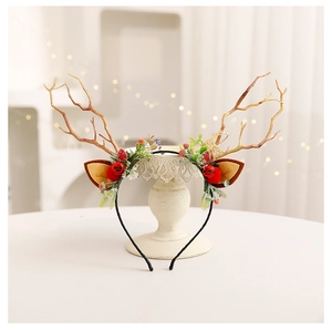 Detail view of brown reindeer antlers headband with festive red bells and faux berries