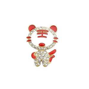 Sparkly tiger brooch accessory with red enamel and inlaid rhinestones on a metal base