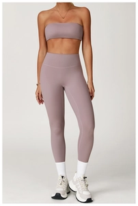 Detail of high-waist mauve yoga pants and matching bandeau sports bra on model