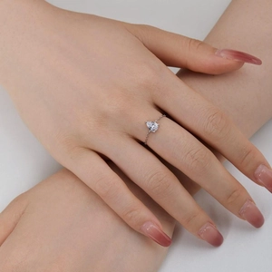 Macro shot of a teardrop zircon stone on a silver adjustable chain ring worn on hand