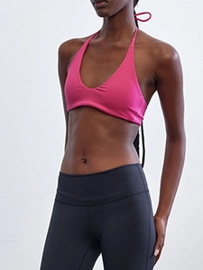 Detail of rose pink halter neck yoga top with high-stretch fabric for athletic wear