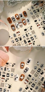 Detail of cartoon nail stickers featuring bears, dogs, and cactus on manicure tips