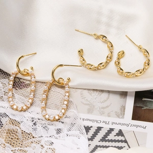18K gold plated drop earrings with pearls and cubic zirconia on elegant white silk background