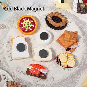 Miniature resin food fridge magnets with black magnet backings on lace tablecloth