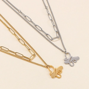 Double-layered gold and silver paperclip necklaces with abstract butterfly pendants