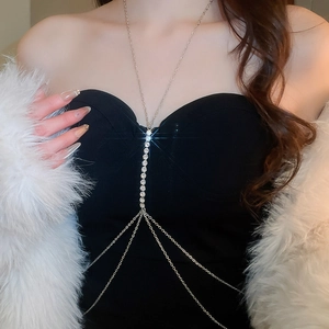Detail of silver body chain with sparkling crystal tassels on a black dress