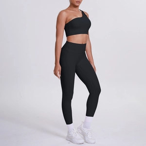Detail of black one-shoulder sports bra and high-waisted yoga pants set for women