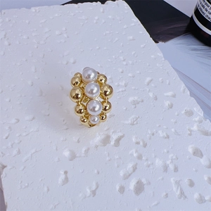 Macro shot of 18K gold plated multi-layer beaded ring featuring central white pearls