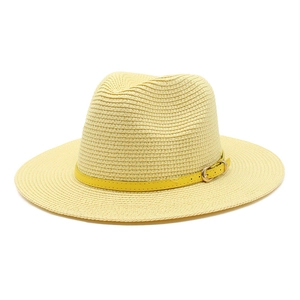 Classic straw Panama sun hat in light yellow with decorative yellow buckled leather band