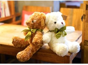 Detailed macro shot showing the soft rose velvet texture of brown and white teddy bears