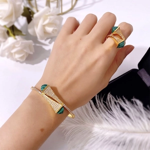 Elegant gold jewelry set with fan-shaped green malachite and micro-pave crystals on model