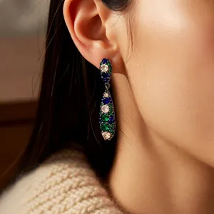 Vintage water drop earrings with blue and green zircon stones on a model