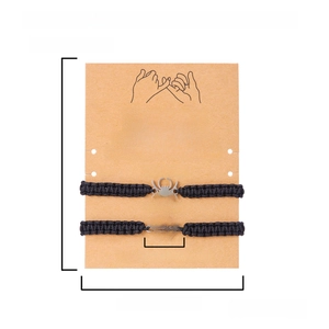 Detailed view of woven Halloween spider bracelets on a measurement card with sizing specs