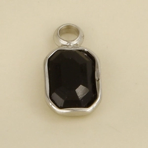Detailed close-up of a black faceted gemstone pendant with a silver stainless steel frame