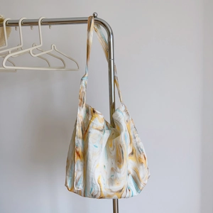Close-up of abstract ink print texture on a lightweight cotton tote shoulder bag