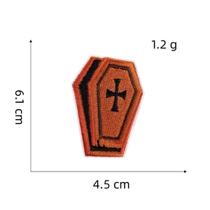 Coffin shaped Halloween patch with orange embroidery and cross design, 6.1 x 4.5 cm