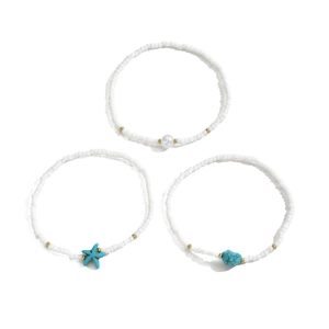 Detailed shot of white seed bead anklet set with turquoise starfish and pearl charms