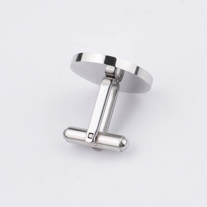 Detail view of mirror-finish round stainless steel cufflinks with T-bar closure
