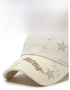 Detail of star embroidery on structured cream baseball cap with a firm curved brim