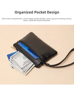 Detail of black litchi texture leather coin purse with double zippers and wrist strap