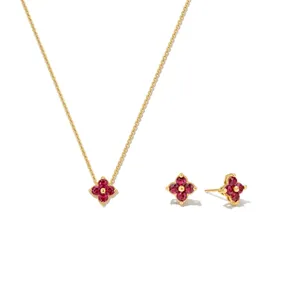 Close-up of a 925 sterling silver four-leaf clover jewelry set with red zircon stones