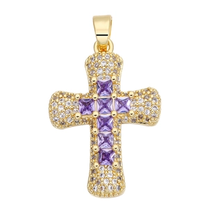 Detailed macro of a gold-plated cross pendant with purple zircon and white crystal pave
