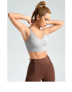 Detail view of high-waist dark brown yoga leggings with side pockets and grey sports bra
