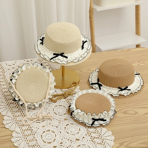 Straw sun hat set with ruffled edges and black ribbon bows for women and girls