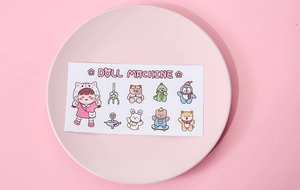 Close-up of cute waterproof cartoon stickers with doll machine motifs on pink background