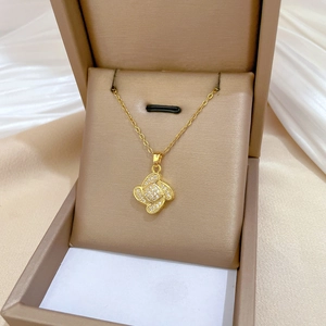 Detail showing clover pendant with micro-pave zircons in a luxury jewelry gift box