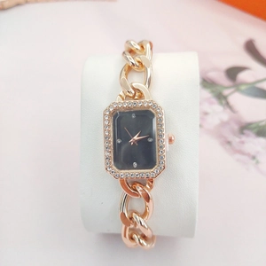 Elegant rose gold women's watch with a black rectangular diamond dial on a chain strap