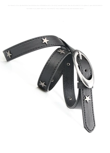 Detail of black leather belt with silver star studs and vintage oval buckle on white background