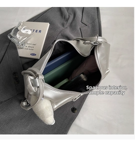 Spacious interior of silver metallic tote bag showing laptop, umbrella and plush charm