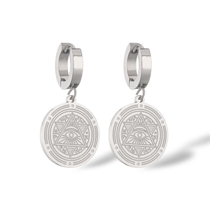 Macro view of silver round drop earrings with mystic evil eye and hexagram engravings