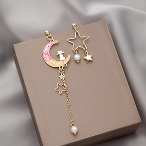 Asymmetric gold earrings with cat moon stars and peach gradient enamel drops