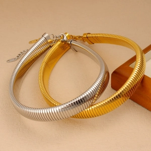 Detail of gold and silver snake chain chokers with lobster clasps and extension links