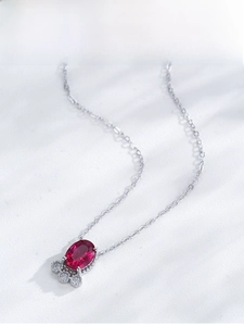 Detail shot of a S925 silver necklace with ruby oval pendant and sparkling zircons
