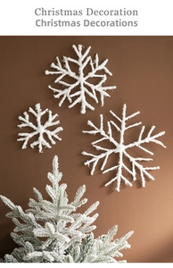 Detailed view of white snowflake ornaments and mini pine tree for Christmas decor