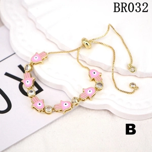 Detail of Hamsa hand bracelet with pink enamel and adjustable gold slide clasp