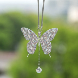 Close-up of diamond butterfly car pendant with sparkling rhinestones and silver metal chain