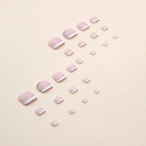 White French tip press-on toenails with subtle pink base and rhinestones for women