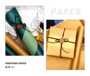 Detail of emerald green and gold gift wrapping paper with wax seal and jute twine