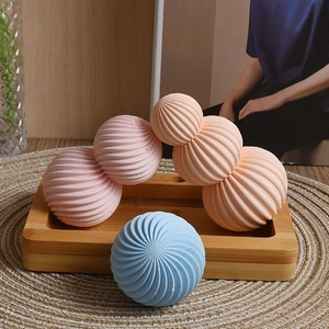 Detailed view of Morandi-colored geometric candle crafts with spiral vortex textures